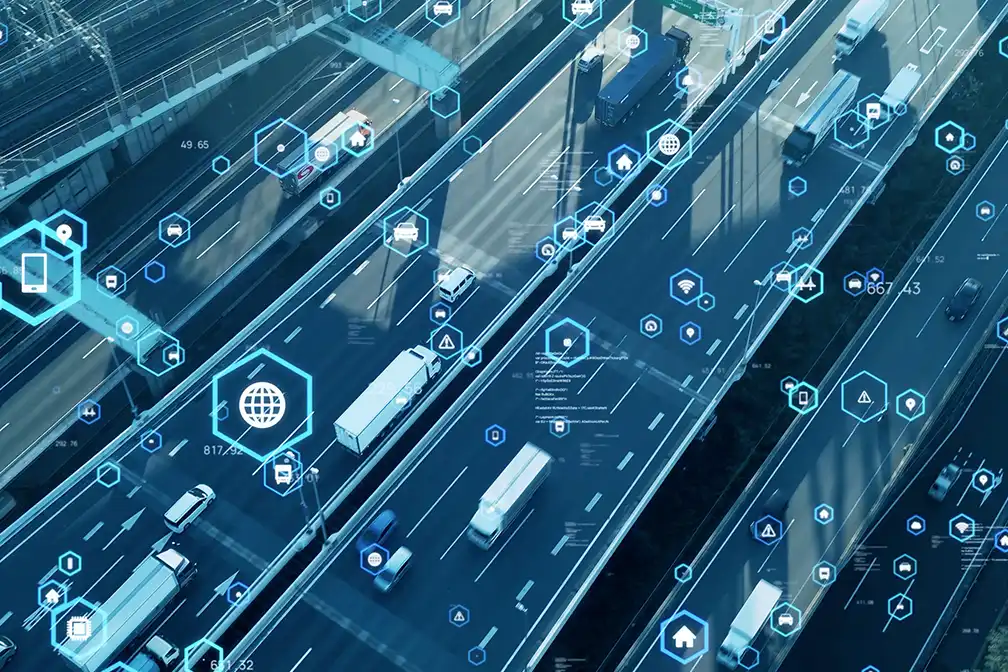 Highway with moving traffic overlaid by blue digital icons and hexagons symbolizing connected smart transport networks. (Informative)
